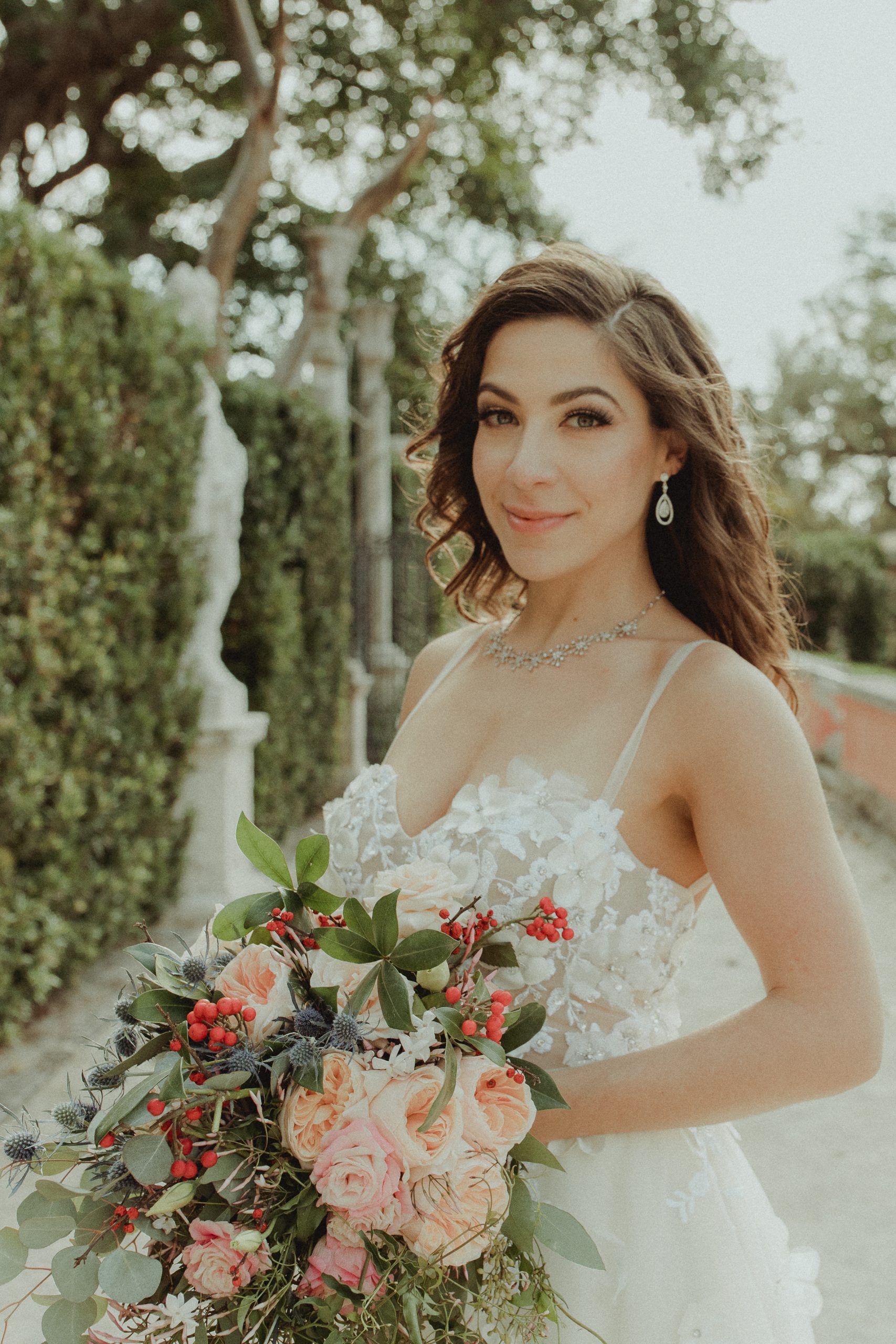 Bride portrait holding her bouquet in the Vizcaya gardens Miami